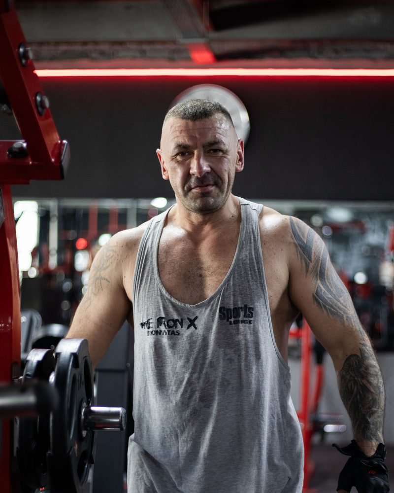 Valdas in a Sports Lodge vest between sets at the gym
