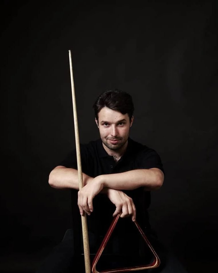 Vilius Schulte holding a pool cue and triangle