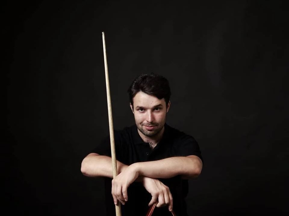 Vilius Schulte with a pool cue and triangle