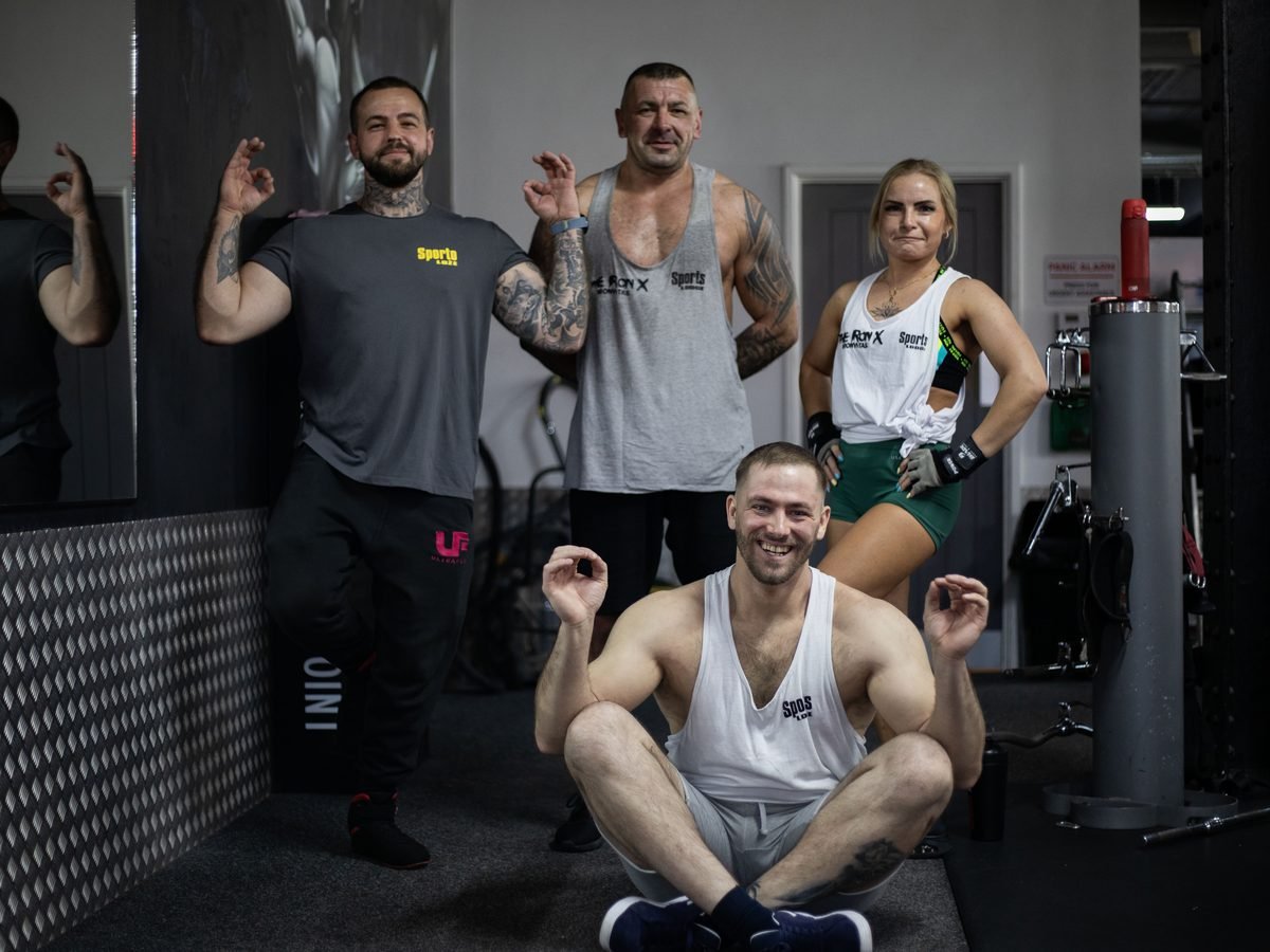 Sports Lodge members posing together on a gym floor