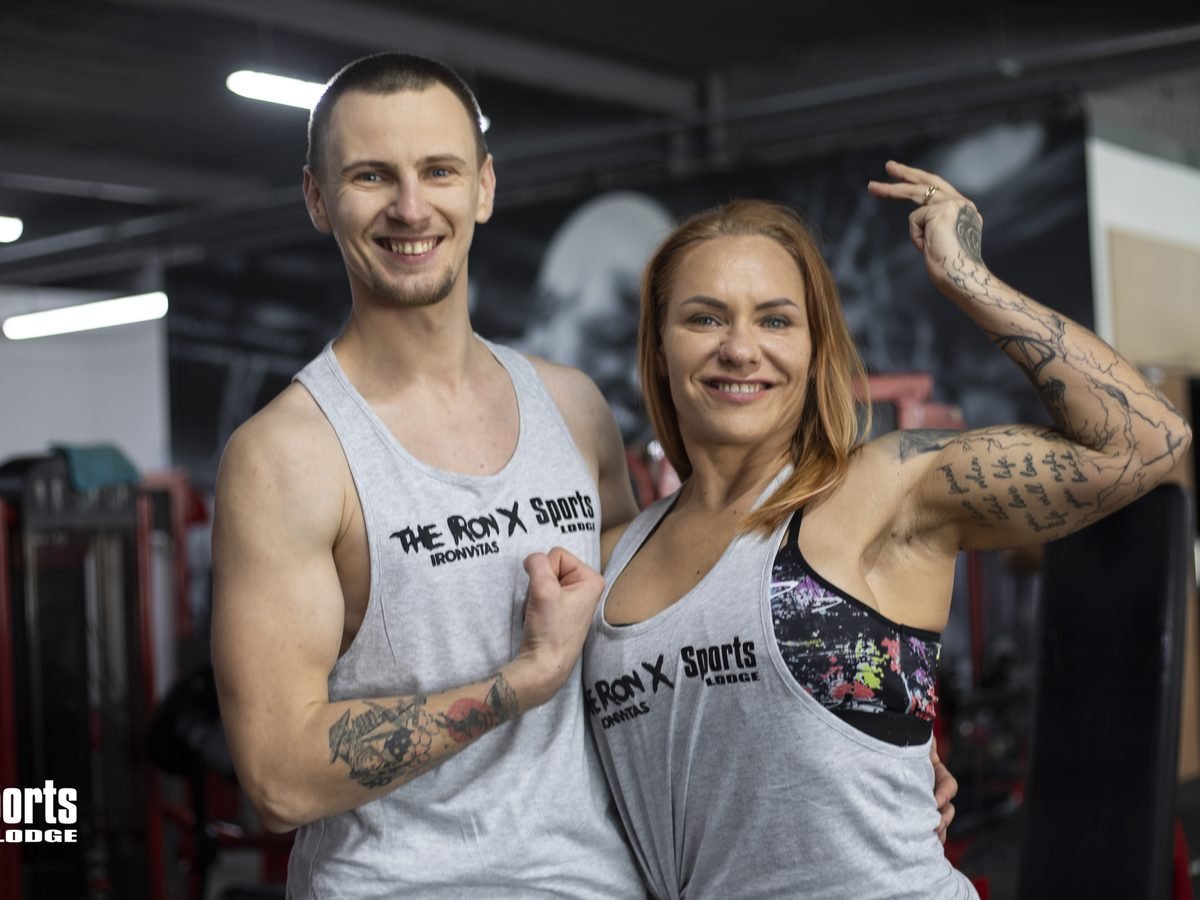 Two Sports Lodge members flexing together in the gym