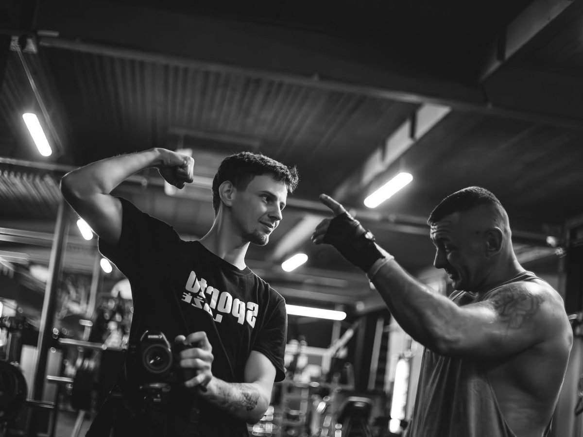 Black and white shot of a coach working with an athlete