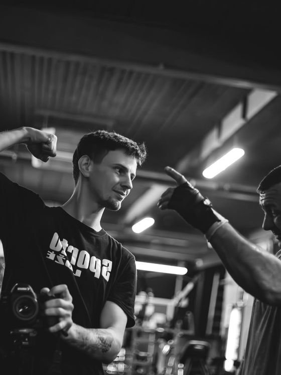 Black and white shot of a fighter training on a gym floor